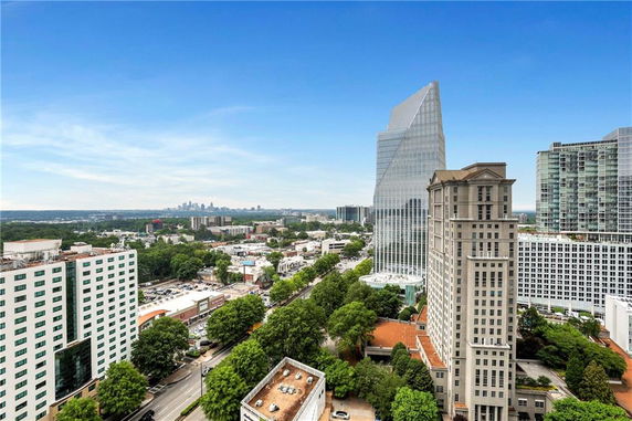 Cityscape view with tall buildings and skyline in the distance.