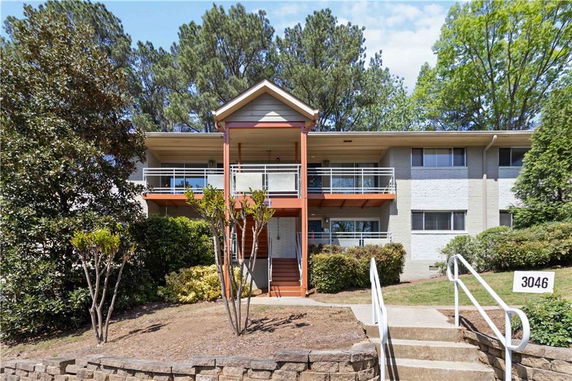 Front view of a two-story building with balconies and a central entrance.