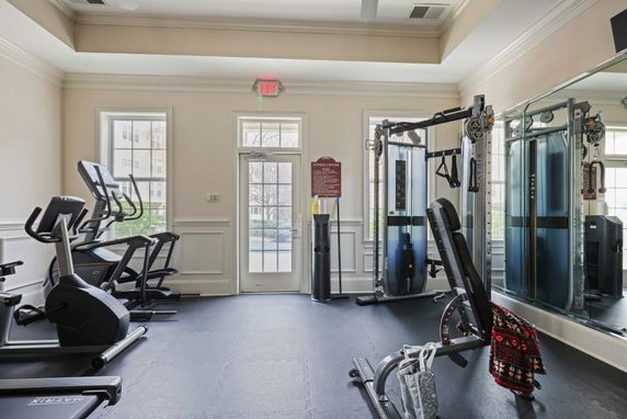Indoor gym area with exercise equipment and mirrors.