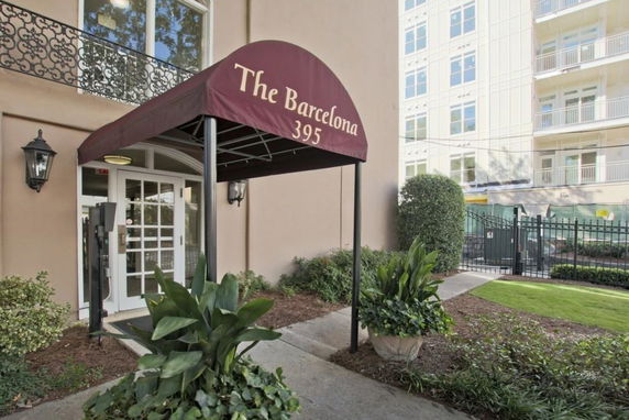 Entrance view of a building with an awning labeled 'The Barcelona 395'.