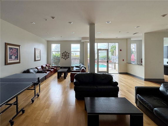 Recreation room with leather sofas and a ping pong table.