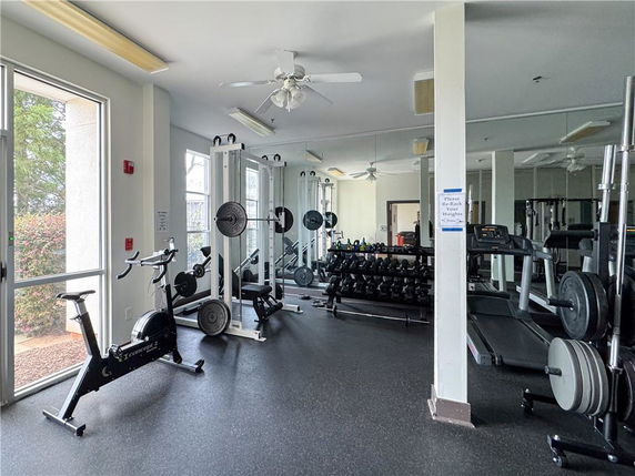 Indoor gym area with exercise equipment and weights.