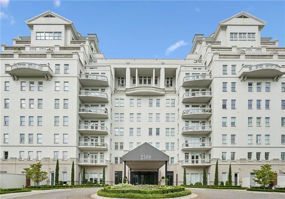 Front view of a multi-story residential building with balconies.