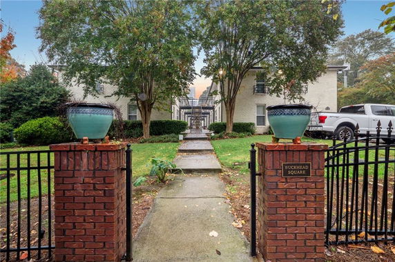 Front view of a residential building with two-story structure and gate entrance.