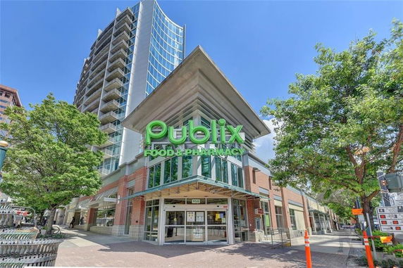 Front view of a multi-story building with a Publix store on the ground floor.