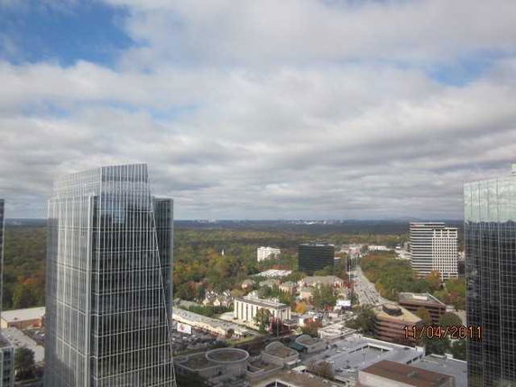 Panoramic view of a cityscape with tall buildings and surrounding area.