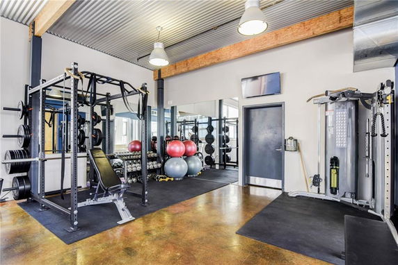 Indoor gym area with fitness equipment and weights