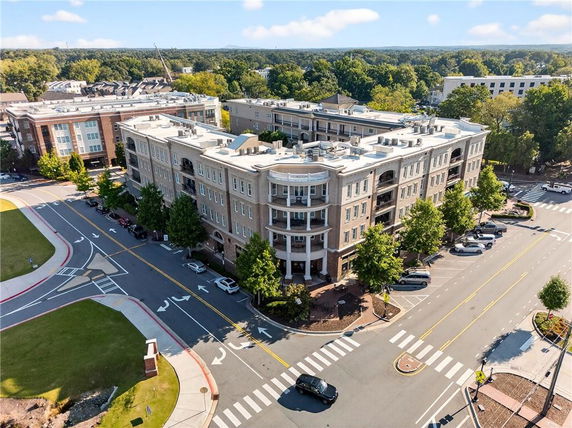 Aerial view of a multi-story apartment building at a street corner.