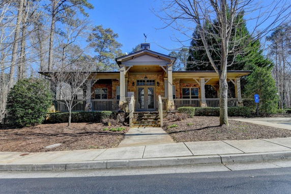 Front view of a single-story house with a covered porch and steps leading to the entrance.