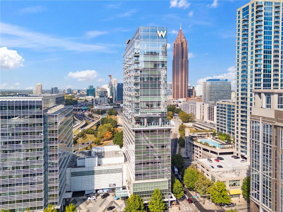 Elevated view of a modern skyscraper with a glass facade in an urban area.