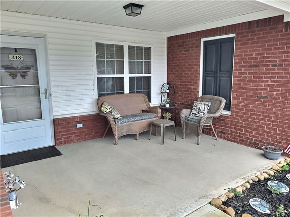 Front view of a house with a brick exterior and a covered porch.
