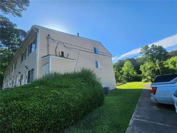 Front view of a two-story building with beige siding.