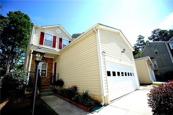 Front view of a two-story house with a garage.