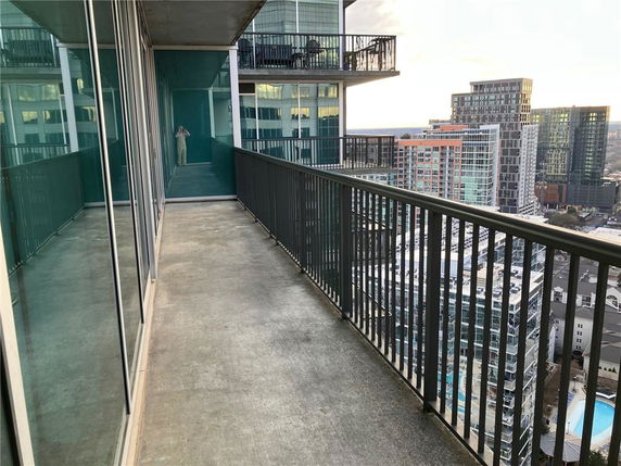 Balcony view of high-rise buildings in a cityscape.