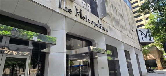 Front view of a commercial building named The Metropolitan.