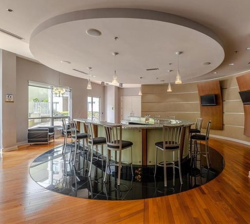Indoor club house area with a circular bar and modern seating.