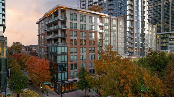 Front view of a mid-rise apartment building with balconies.