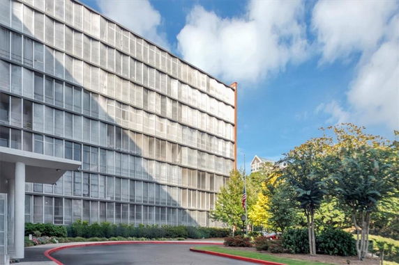 Front view of a multi-story building with glass windows.