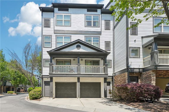 Front view of a multi-story residential building with a double garage.