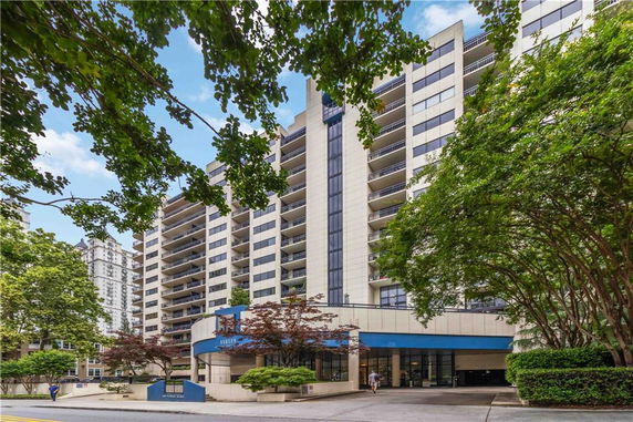 Front view of a multi-story apartment building with balconies.