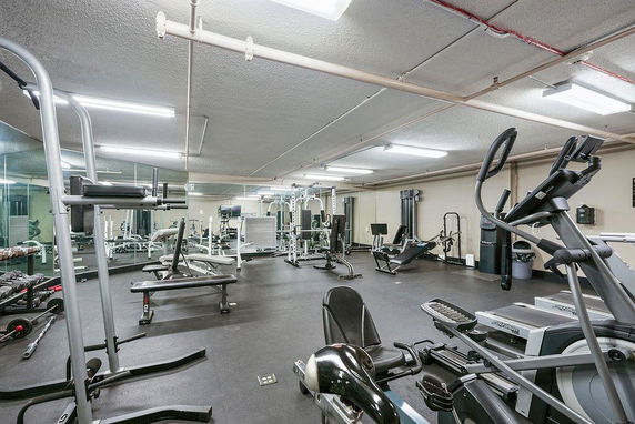 Indoor gym area with various exercise equipment.