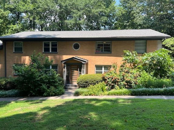 Front view of a two-story brick house with a central entrance.
