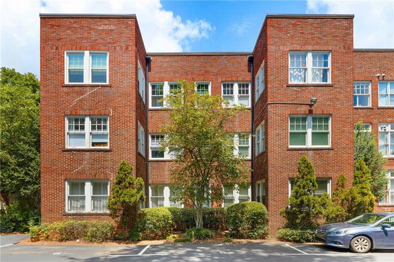 Front view of a three-story brick apartment building.