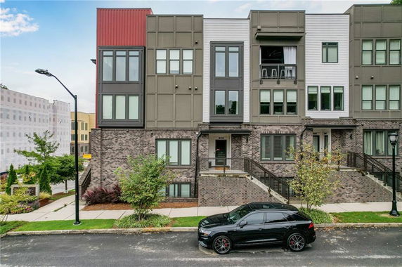 Front view of a multi-story modern townhouse.