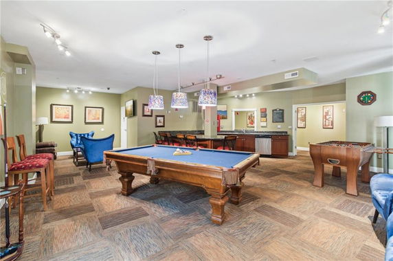 Recreation area with a pool table and seating.