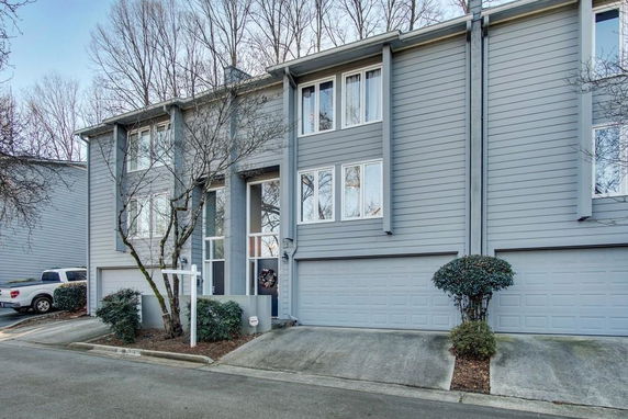 Front view of a two-story townhouse with a double garage.