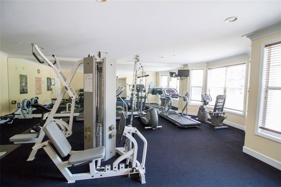 Gym area with various exercise machines and equipment.