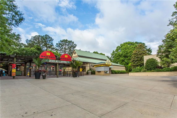 Front view of the main entrance to Zoo Atlanta with ticket booths and signage.