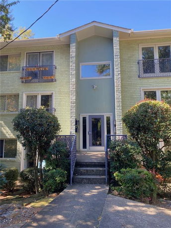 Front view of a multi-story building with a central entrance.