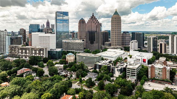 Panoramic view of a city skyline with tall buildings and residential areas below.