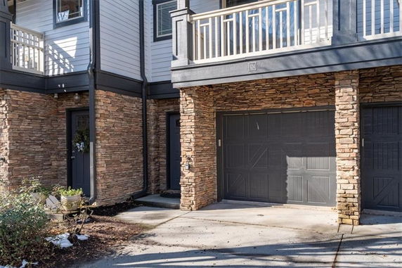 Front view of a house with stone accents and a double garage.