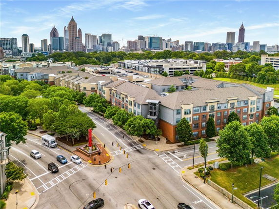 Aerial view of an urban area with apartment buildings and a city skyline in the background.