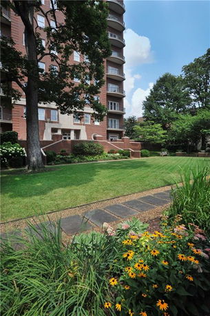Front view of a multi-story apartment building with balconies.