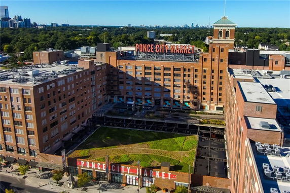 Front view of a large multi-story brick building labeled Ponce City Market.