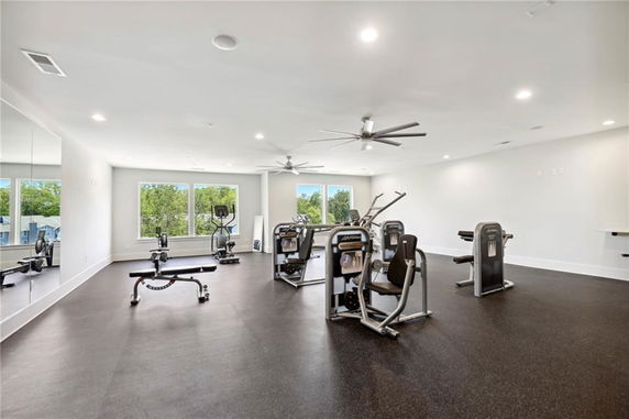 Room with gym equipment and ceiling fans.