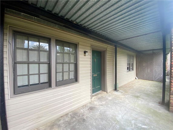 Front view of a house with a covered entrance and windows.