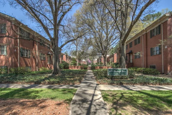 Front view of a two-story brick residential complex with a central walkway.