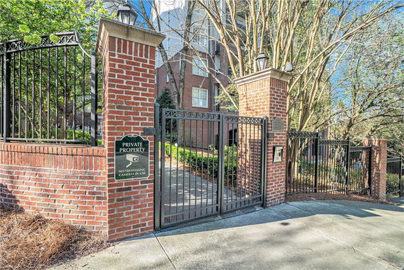 Front view of a gated entrance to a multi-story building.