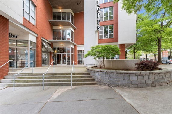 Front view of a multi-story building with brick and glass facade.