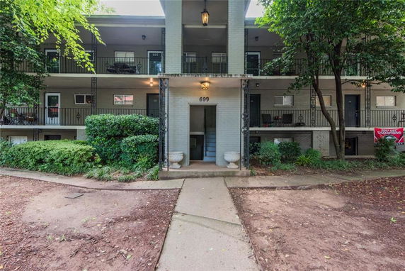 Front view of a two-story apartment building with balconies.