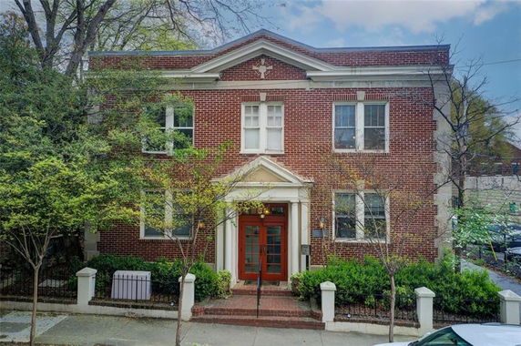 Front view of a two-story brick building with a central entrance.