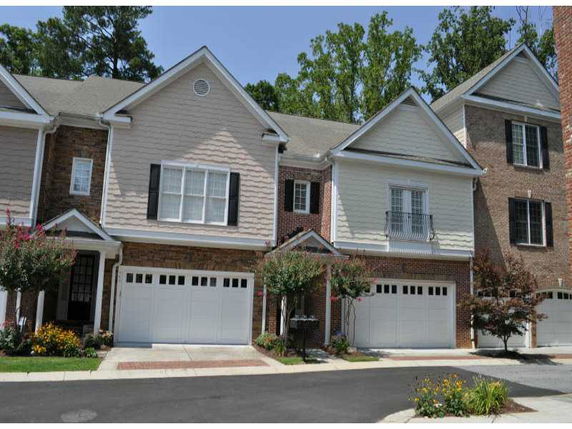 Front view of two-story townhouses with garages.