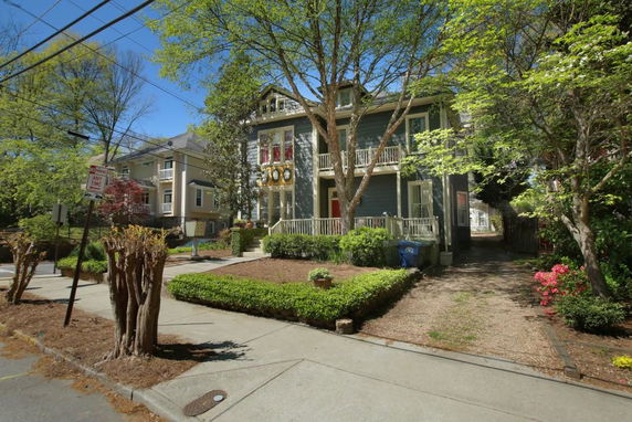 Front view of a two-story house with a porch and a balcony.