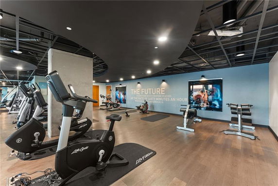 Interior view of a gym area with exercise equipment.