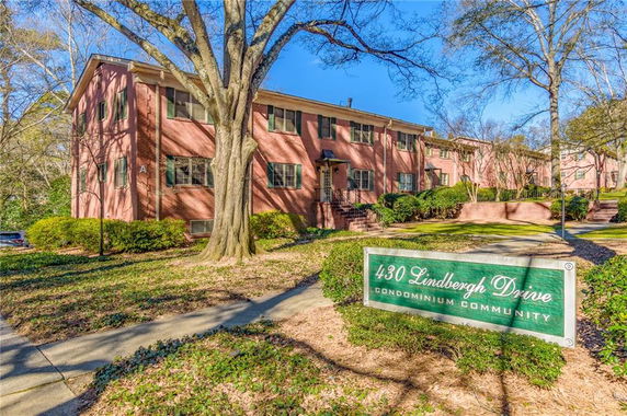 Front view of a two-story condominium building with a brick exterior.