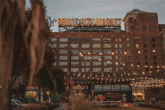 Front view of a large multi-story building with signage at the top.
